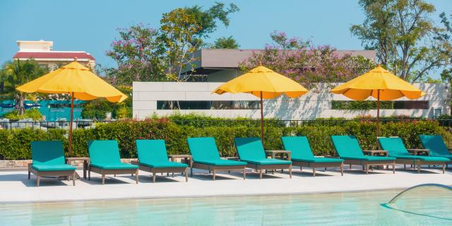 Umbrella And Chair Around Swimming Pool