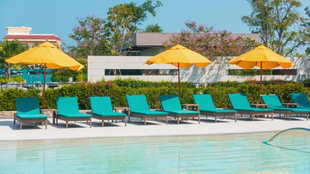Umbrella And Chair Around Swimming Pool